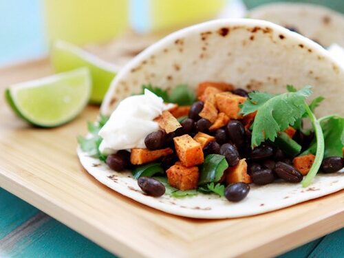 bean taco on cutting board with lime