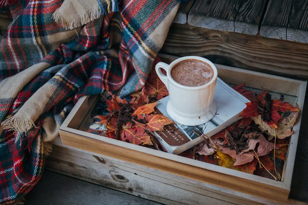 Autum wooden box with mug of cocoa and blanket